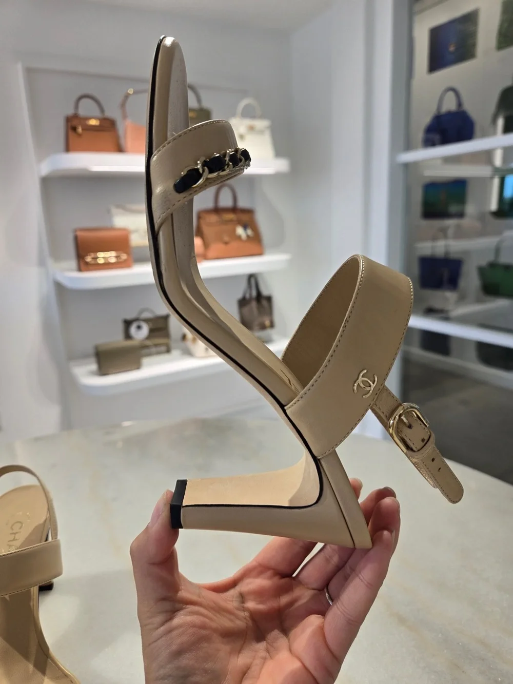 CHANEL Beige Slingback Heels with Black-and-Gold Chain